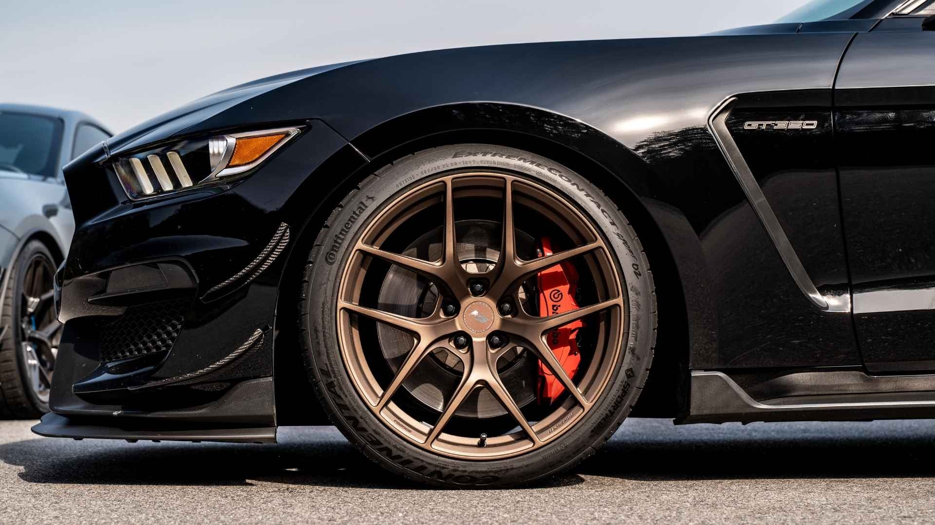 Black Ford Mustang GT350 with bronze forged magnesium performance wheels showcasing a lightweight wheel upgrade for improved handling, braking, and performance.