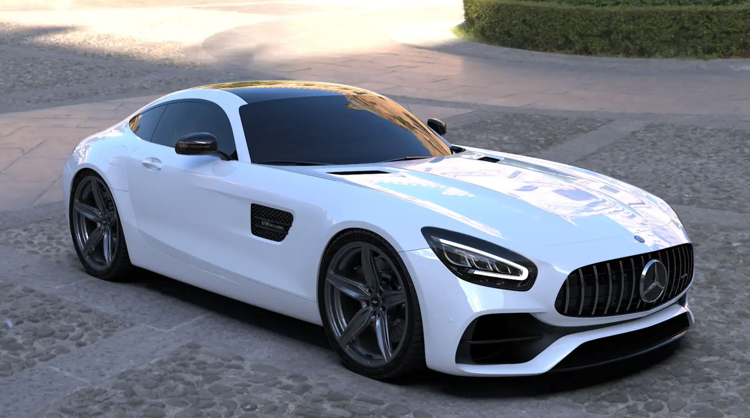 A white Mercedes-Benz sports car parked on a cobblestone street, featuring forged rims with a five-spoke design