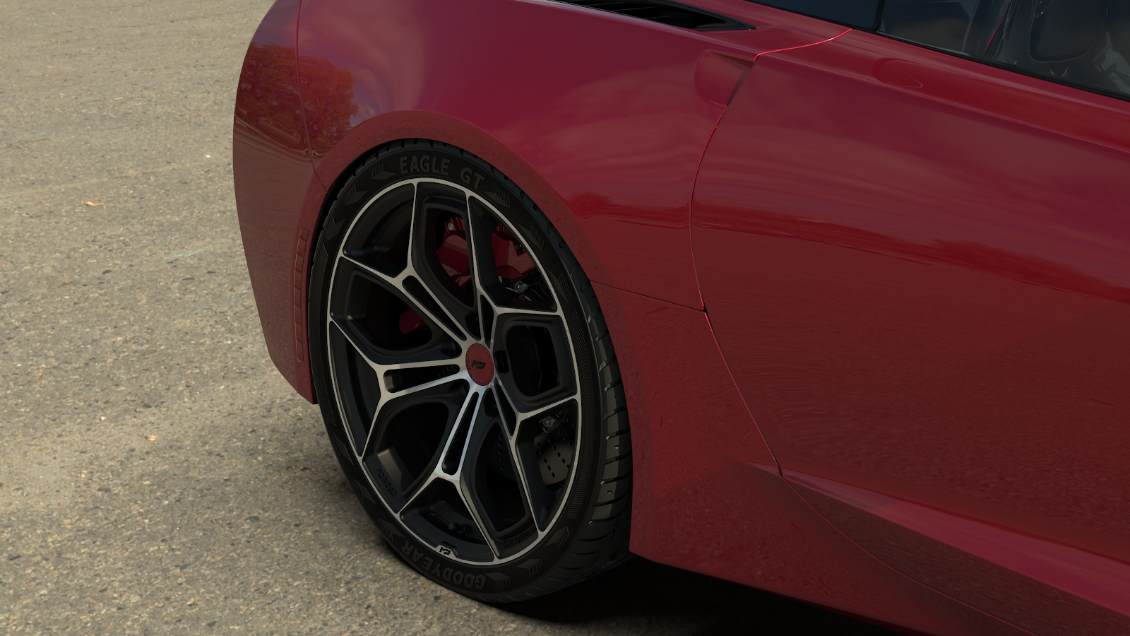 Close-up of MP01 forged magnesium wheels on a red Corvette, highlighting lightweight design and performance styling.
